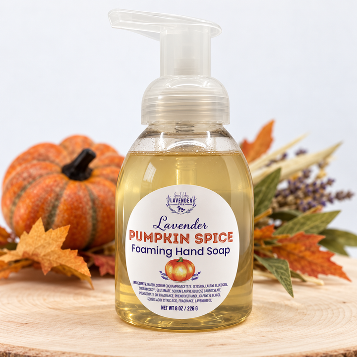 Lavender Pumpkin Spice Foaming Hand Soap on a wood slice with a pumpkin and fall leaves