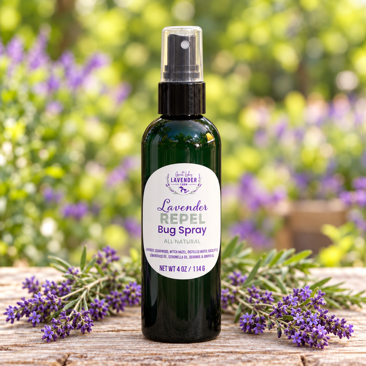 Lavender Repel Bug Spray, 4 oz green spray bottle on a rustic table with lavender sprigs in a sunny garden