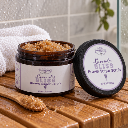 Lavender Bliss Brown Sugar Scrub in an open amber jar with a spoon of scrub on a wet wooden shower bench