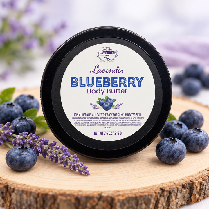 Lavender Blueberry Body Butter, 7.5 oz jar on a wood slice with blueberries and lavender sprigs