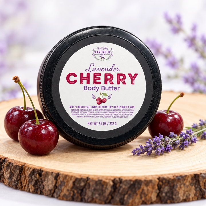 Lavender Cherry Body Butter, 7.5 oz jar on a wood slice with fresh cherries and lavender sprigs
