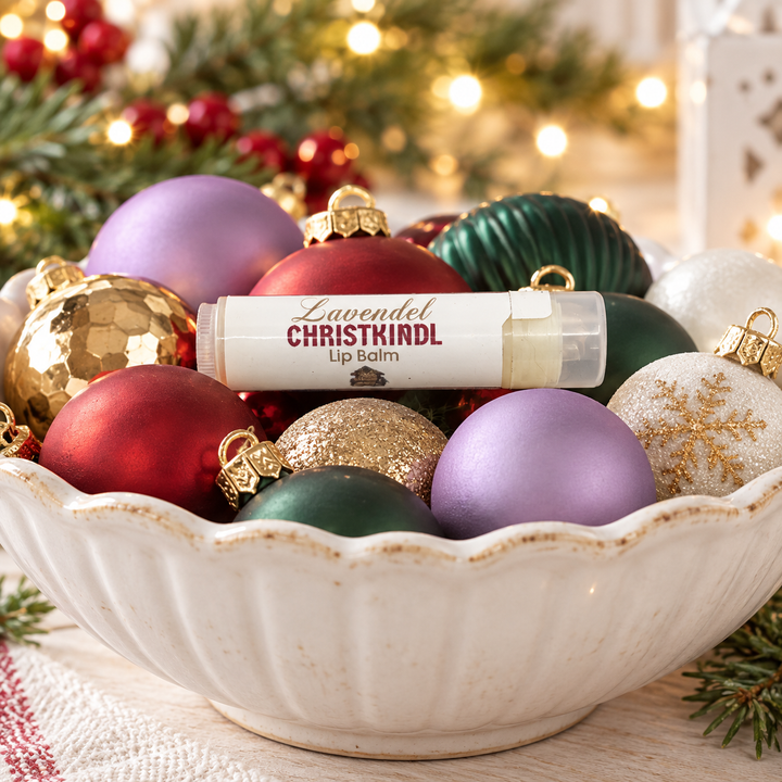 Lavender Christkindl lip balm in a bowl of Christmas ornaments
