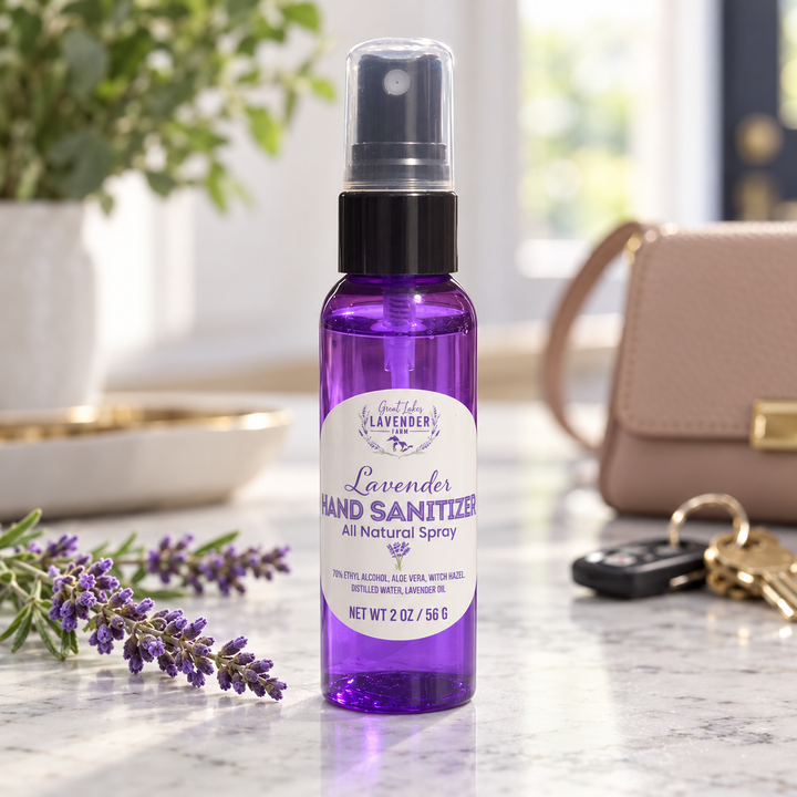 Lavender Hand Sanitizer, 2 oz purple spray bottle on a counter with lavender, keys and a handbag