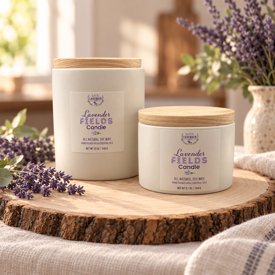Lavender Fields Candles, large and small ceramic jars with wood lids, on a wood slice with lavender sprigs