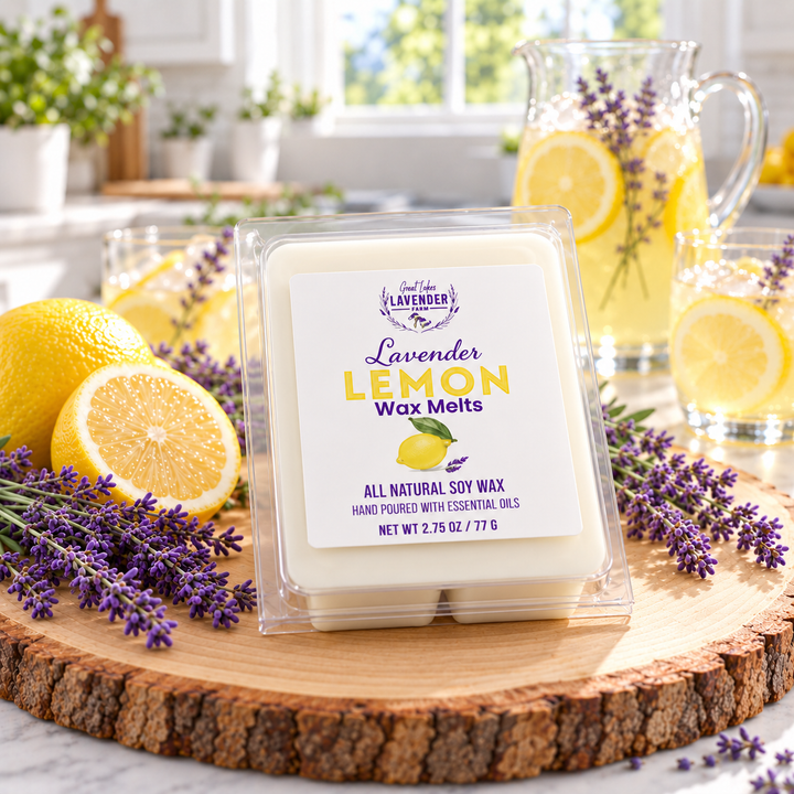 Lavender Lemon Wax Melts clamshell on a wood slice with lemon halves, lavender and a pitcher of lemonade