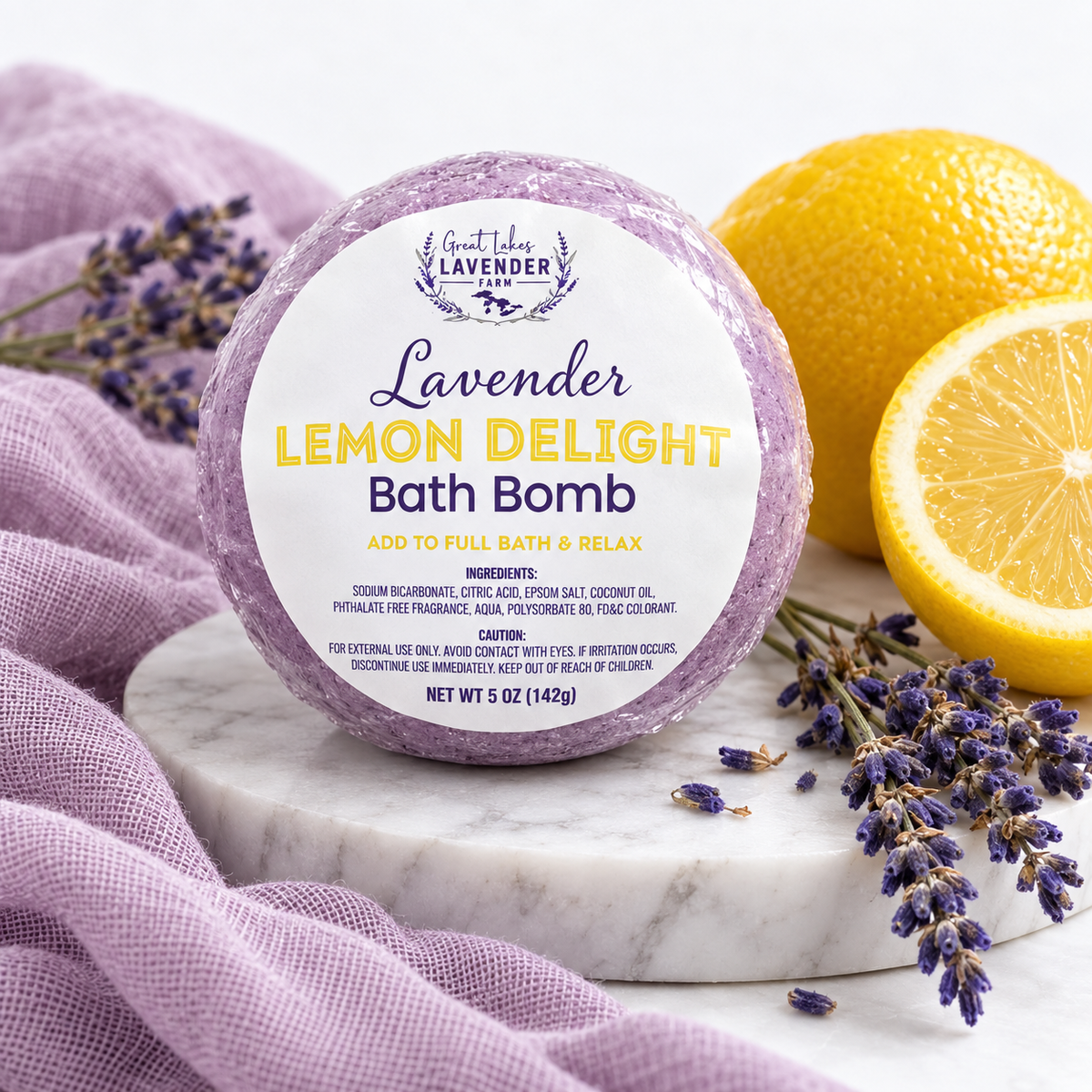 Lavender Lemon Delight Bath Bomb 5 oz in label wrap on a marble round with lemons and lavender