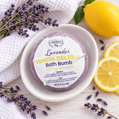 Lavender Lemon Delight Bath Bomb in label wrap on a white dish with lemon slices and lavender