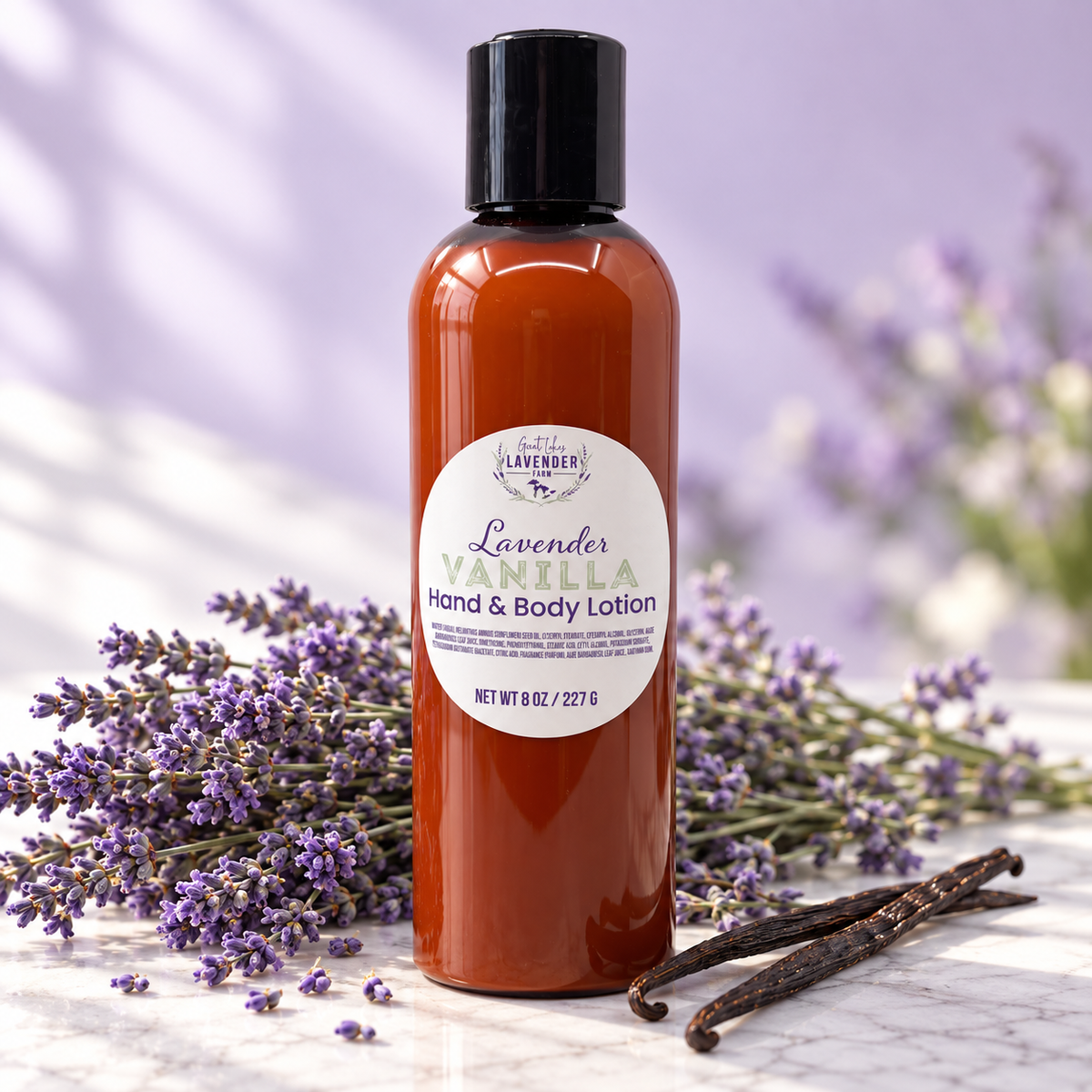 Lavender Vanilla Hand & Body Lotion in an amber bottle surrounded by fresh lavender sprigs and vanilla beans