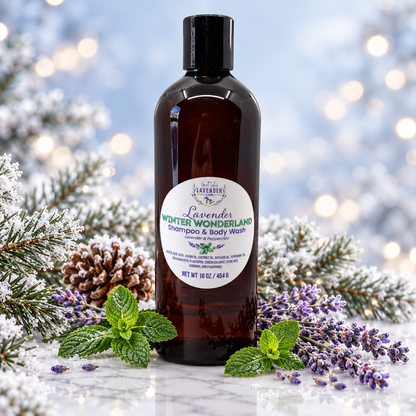 Lavender Winter Wonderland Shampoo and Body Wash bottle standing on a surface surrounded by lavender, mint leaves, pine cones