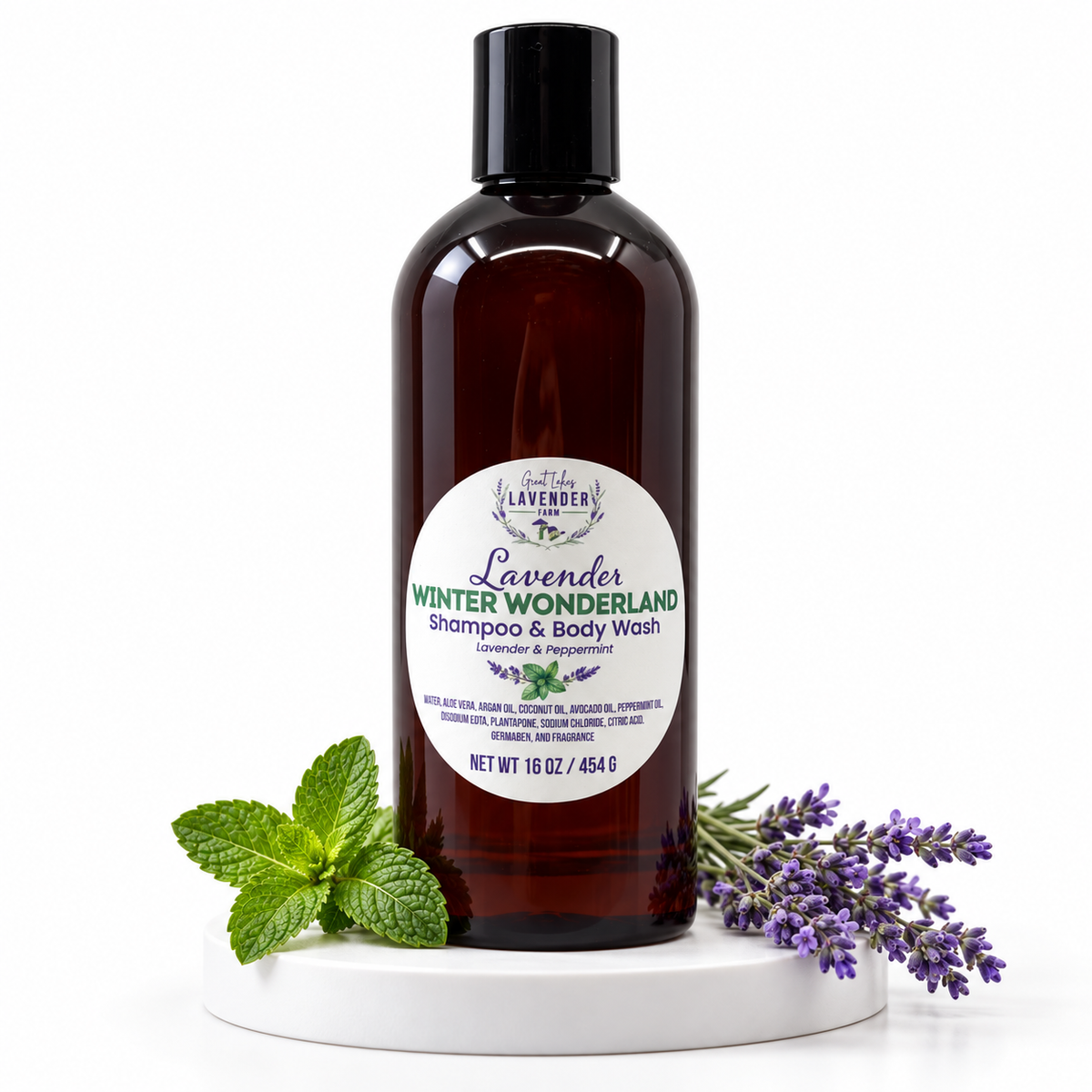 Closeup of Lavender Winter Wonderland Shampoo and Body Wash on marble with sprigs of lavender and mint on white background.