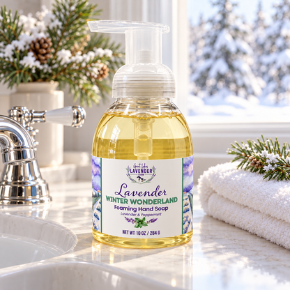Lavender Winter Wonderland Foaming Hand Soap pump bottle by a sink with a snowy window and pine