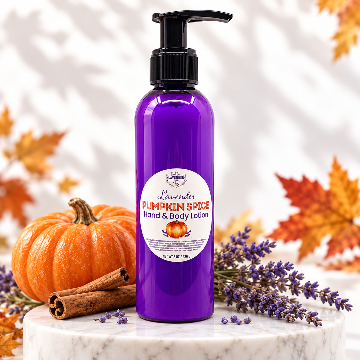 Lavender Pumpkin Spice Hand & Body Lotion on a marble stand with a pumpkin, cinnamon sticks, lavender and fall leaves