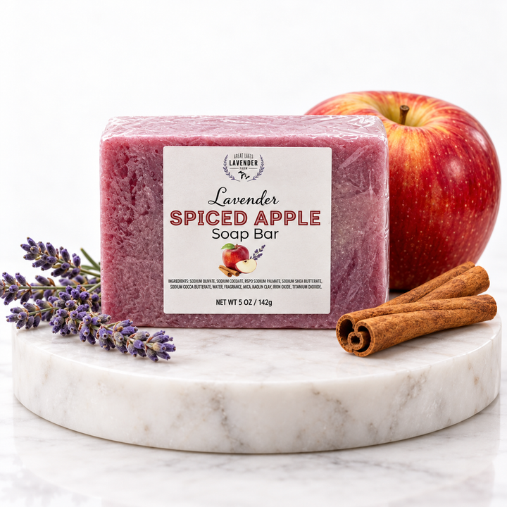 Lavender Spiced Apple Soap Bar, red bar on a marble riser with a red apple, cinnamon sticks and lavender