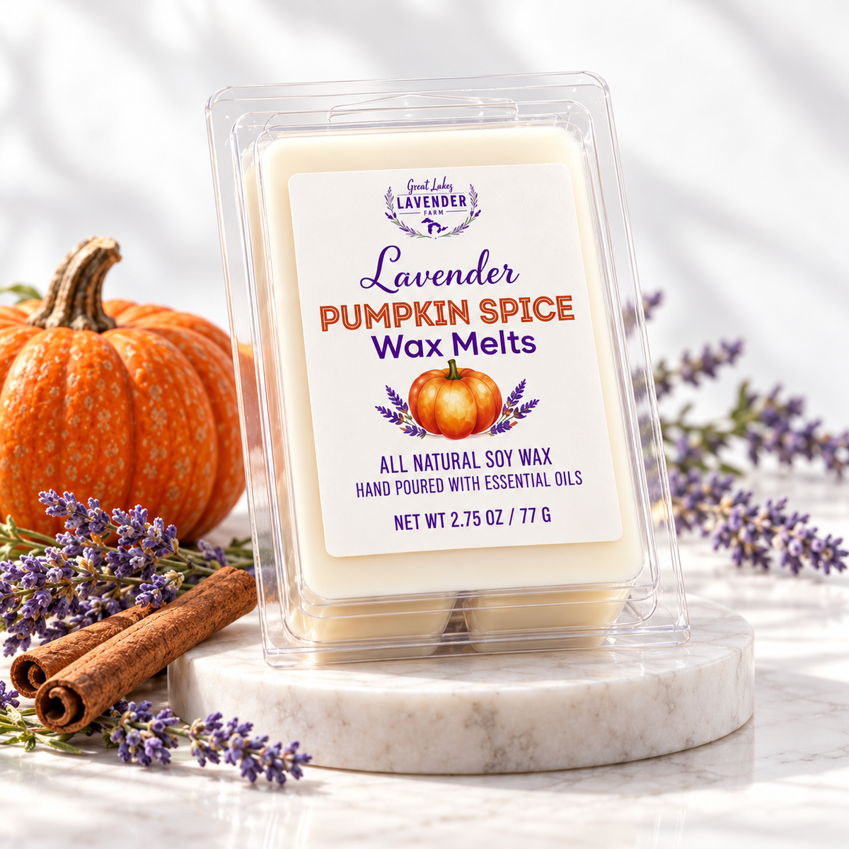 Lavender Pumpkin Spice Wax Melts on a marble stand with a pumpkin, cinnamon sticks and lavender