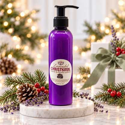 Lavender Christkindl Hand & Body Lotion on a marble stand with pine, pinecones, berries and holiday lights