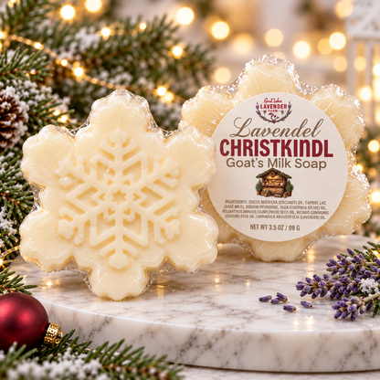 Lavender Christkindl Goat's Milk Bar Soap, snowflake-shaped bars on marble with pine and holiday lights