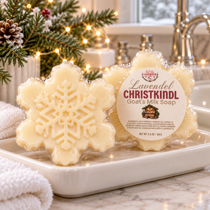 Two snowflake Christkindl goat's milk soaps on a soap dish by the sink