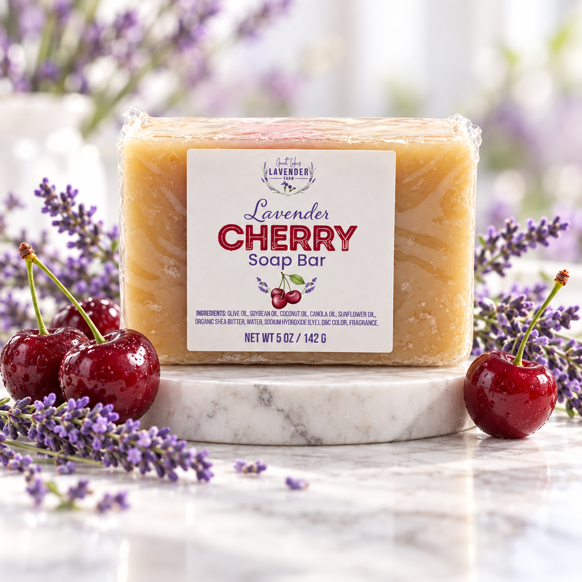 Lavender Cherry Soap Bar on a marble riser with fresh cherries and lavender sprigs