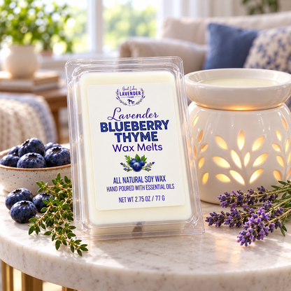 Lavender Blueberry Thyme Wax Melts on a marble table with a lit ceramic warmer, blueberries and lavender