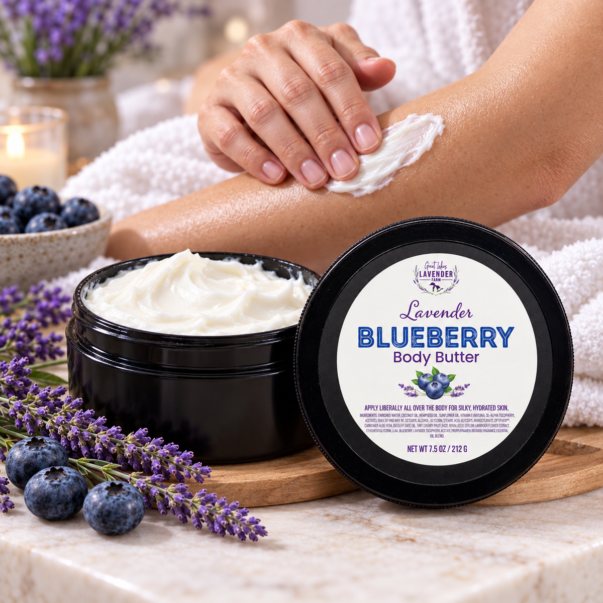 Lavender Blueberry Body Butter open jar on marble as a person rubs the cream into their forearm