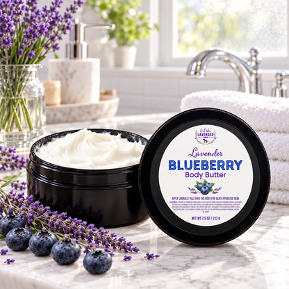 Lavender Blueberry Body Butter open jar on a bathroom counter with blueberries, lavender and towels