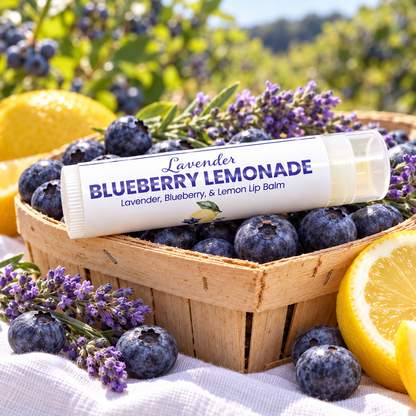 Lavender Blueberry Lemonade Lip Balm resting on a berry basket of blueberries with lemons and lavender