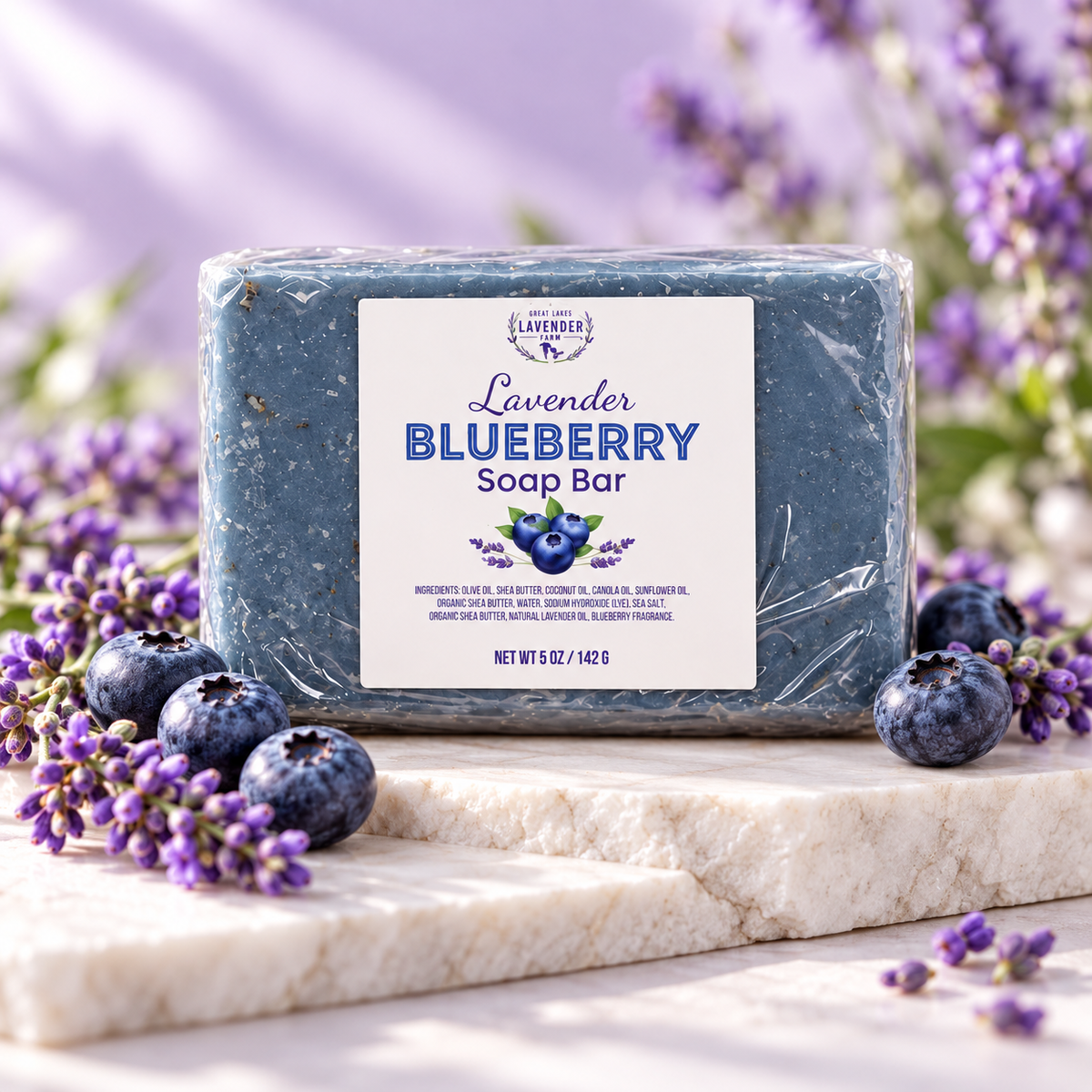 Lavender Blueberry Soap Bar, blue bar in clear wrap on marble with fresh blueberries and lavender sprigs