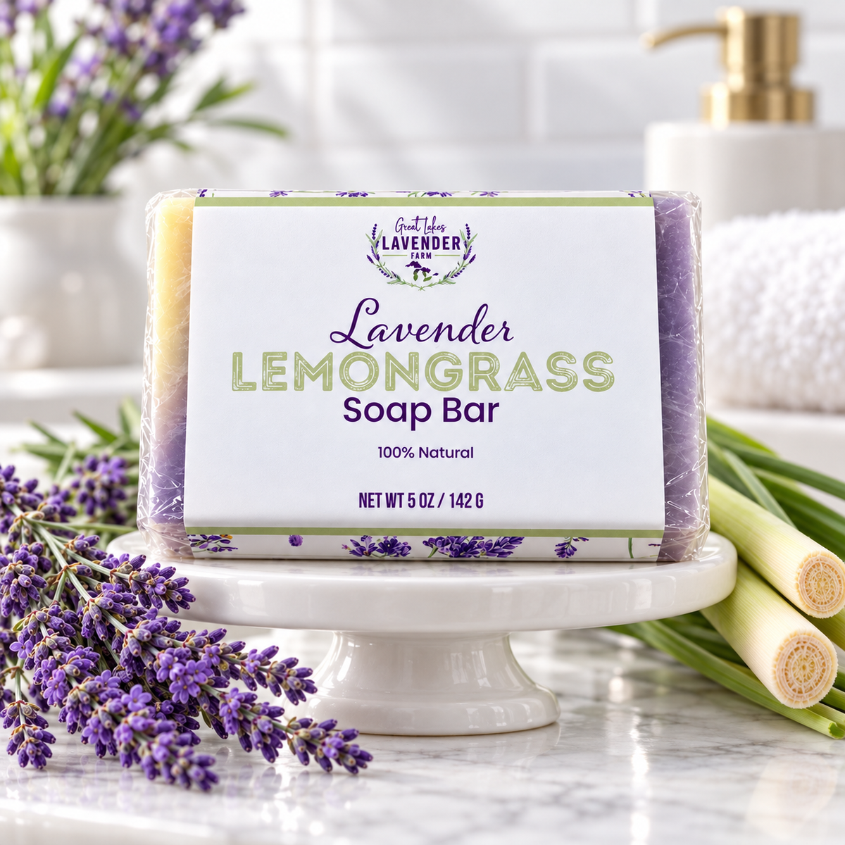 Lavender Lemongrass Bar Soap in its label wrap on a white stand with lavender and lemongrass