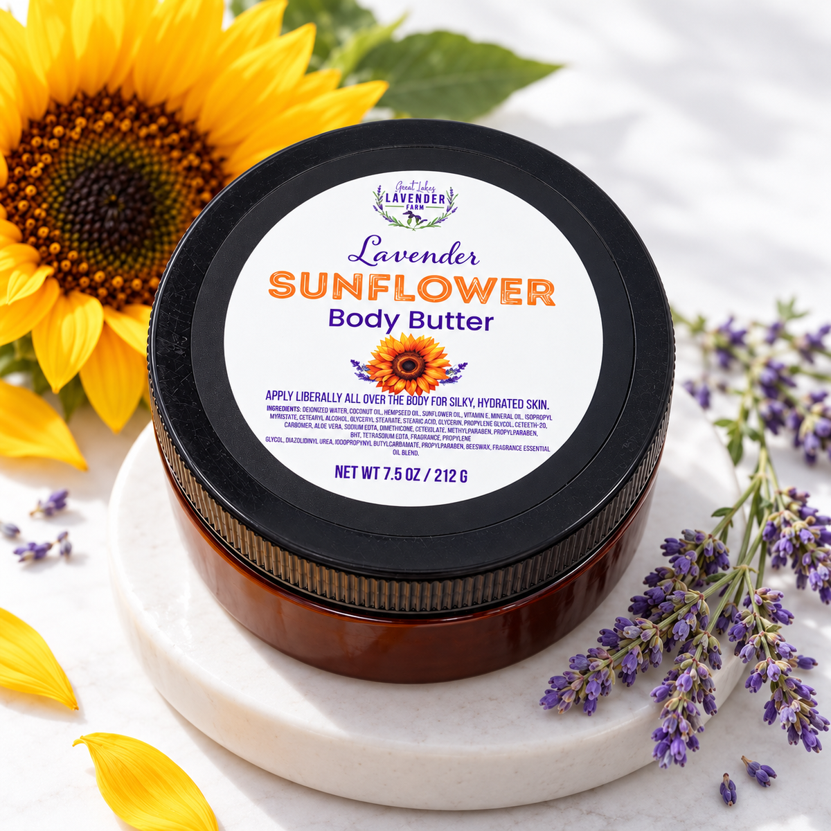 Lavender Sunflower Body Butter on a marble stand with a sunflower, yellow petals and lavender