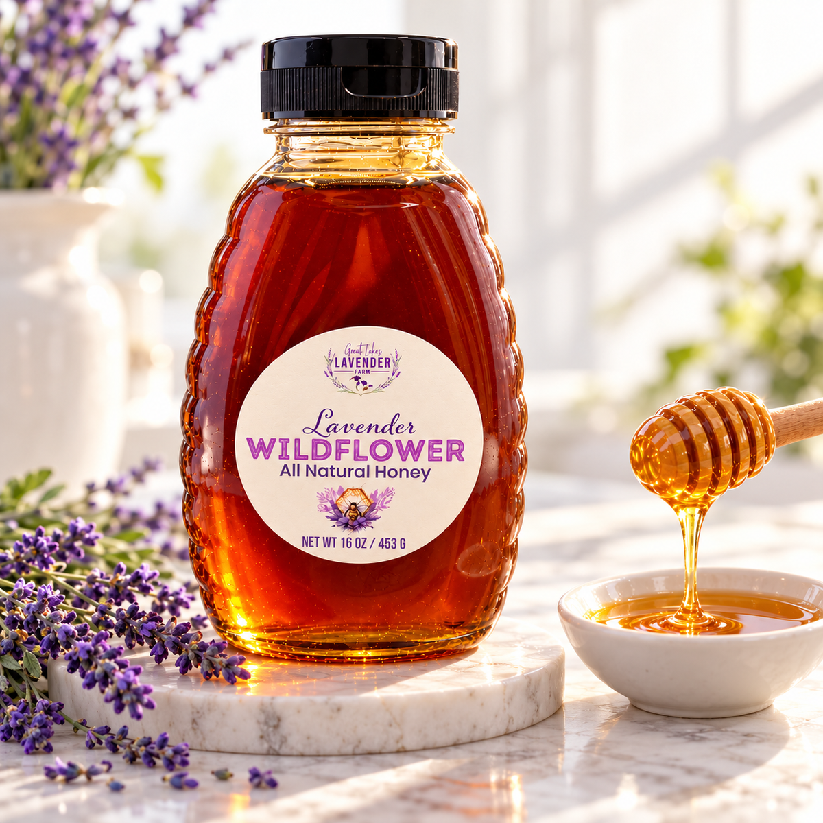 Lavender Wildflower Honey bottle on a marble counter with a honey dipper over a small bowl and lavender