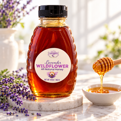Lavender Wildflower Honey bottle on a marble counter with a honey dipper over a small bowl and lavender