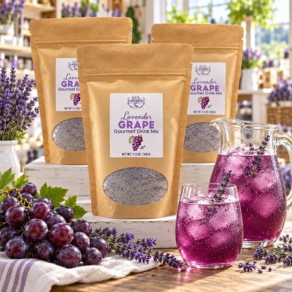 Three Lavender Grape Gourmet Drink Mix pouches beside a pitcher and glass of purple drink and grapes