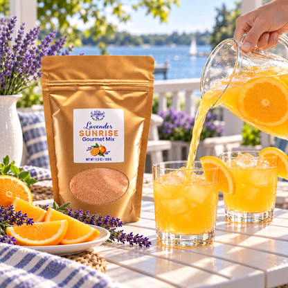 Orange drink poured into glasses beside a pouch of Lavender Sunrise Gourmet Mix on a lakeside patio