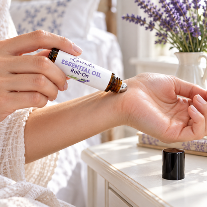 Woman rolling Lavender Essential Oil Roll-On onto her wrist, cap set on a nightstand