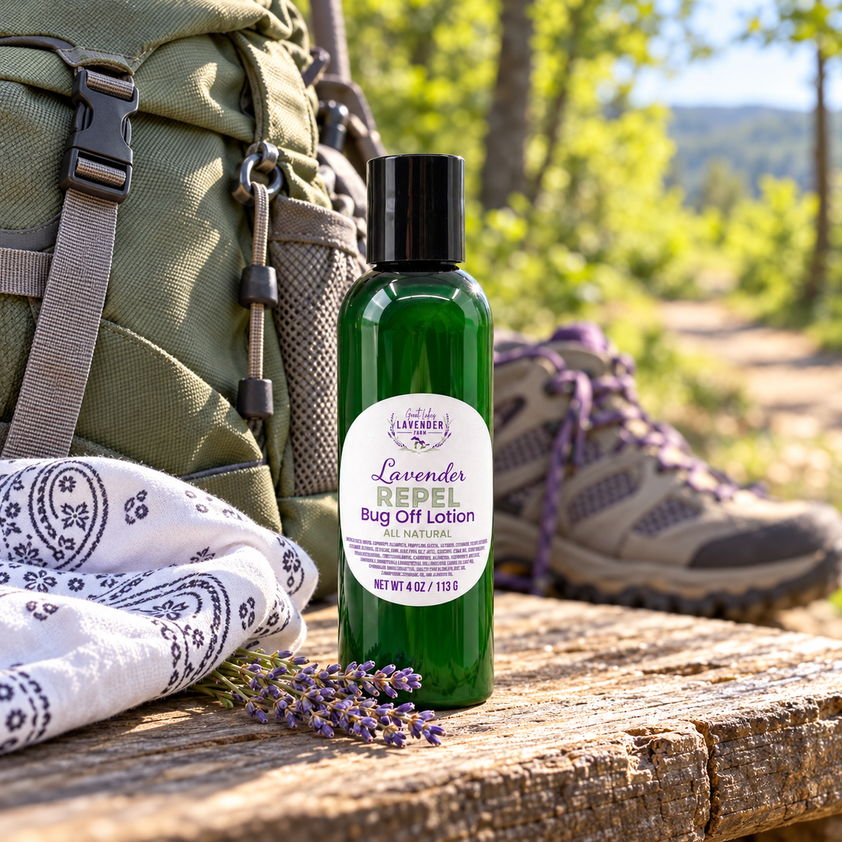Lavender Repel Bug Off Lotion on a rustic table beside a backpack, bandana and hiking boots outdoors