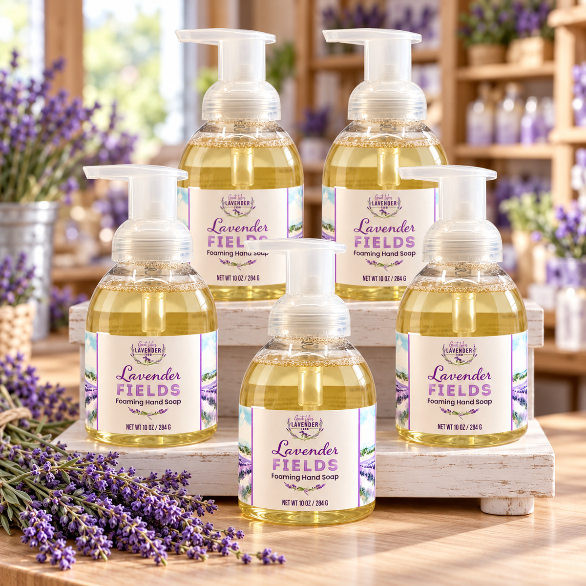 Lavender Fields Foaming Hand Soap bottles grouped on a white wooden stand in a shop