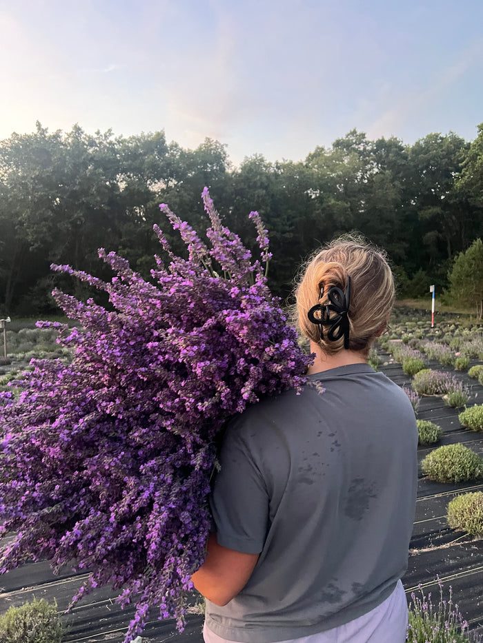 Woman seen from behind with lavender over her shoulder