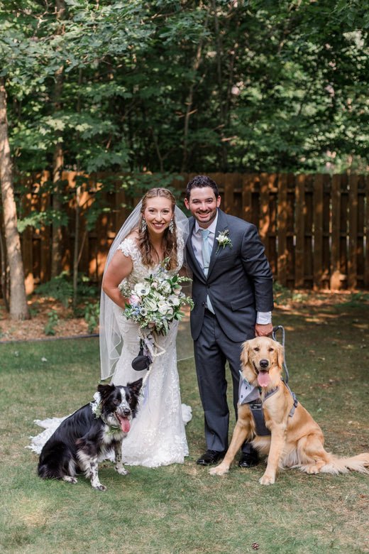 Sierra and Andrew on their wedding day with their two dogs