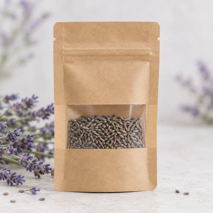 Finnegan Lavender Seeds in a kraft pouch with a window showing seeds, lavender sprigs nearby